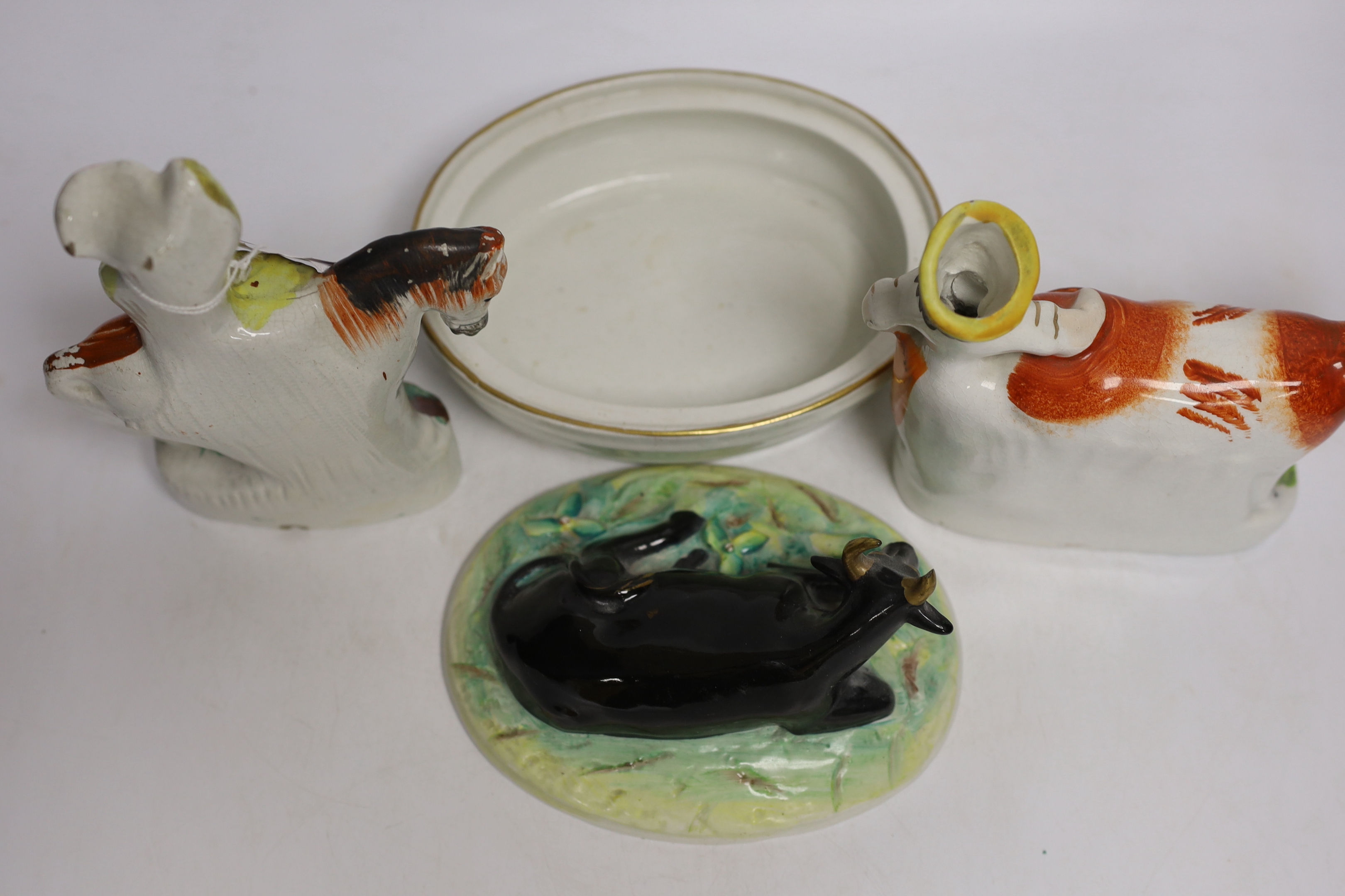 A Victorian Staffordshire cow tureen and cover, and five other Staffordshire figures, largest 18cm wide
